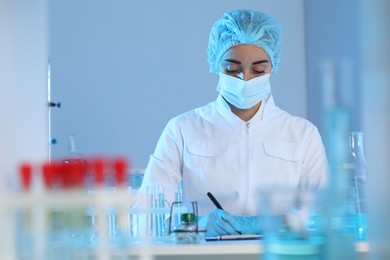 Photo of Scientist with clipboard working in laboratory. Medical research