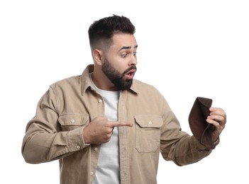 Photo of Confused man pointing at empty wallet on white background