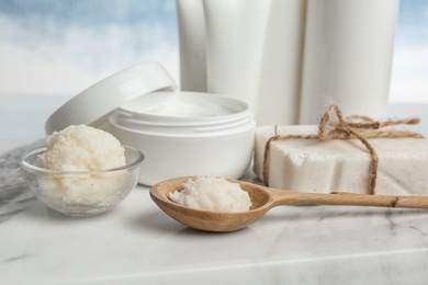 Shea butter and other cosmetic products on marble board