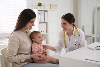 Photo of Mother with her cute baby visiting pediatrician in clinic