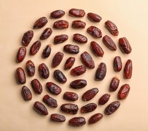Photo of Sweet dried date fruits on color background, top view