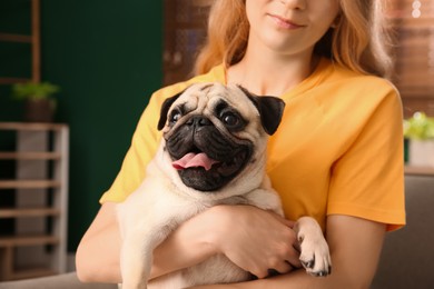 Photo of Woman with cute pug dog at home, closeup. Animal adoption