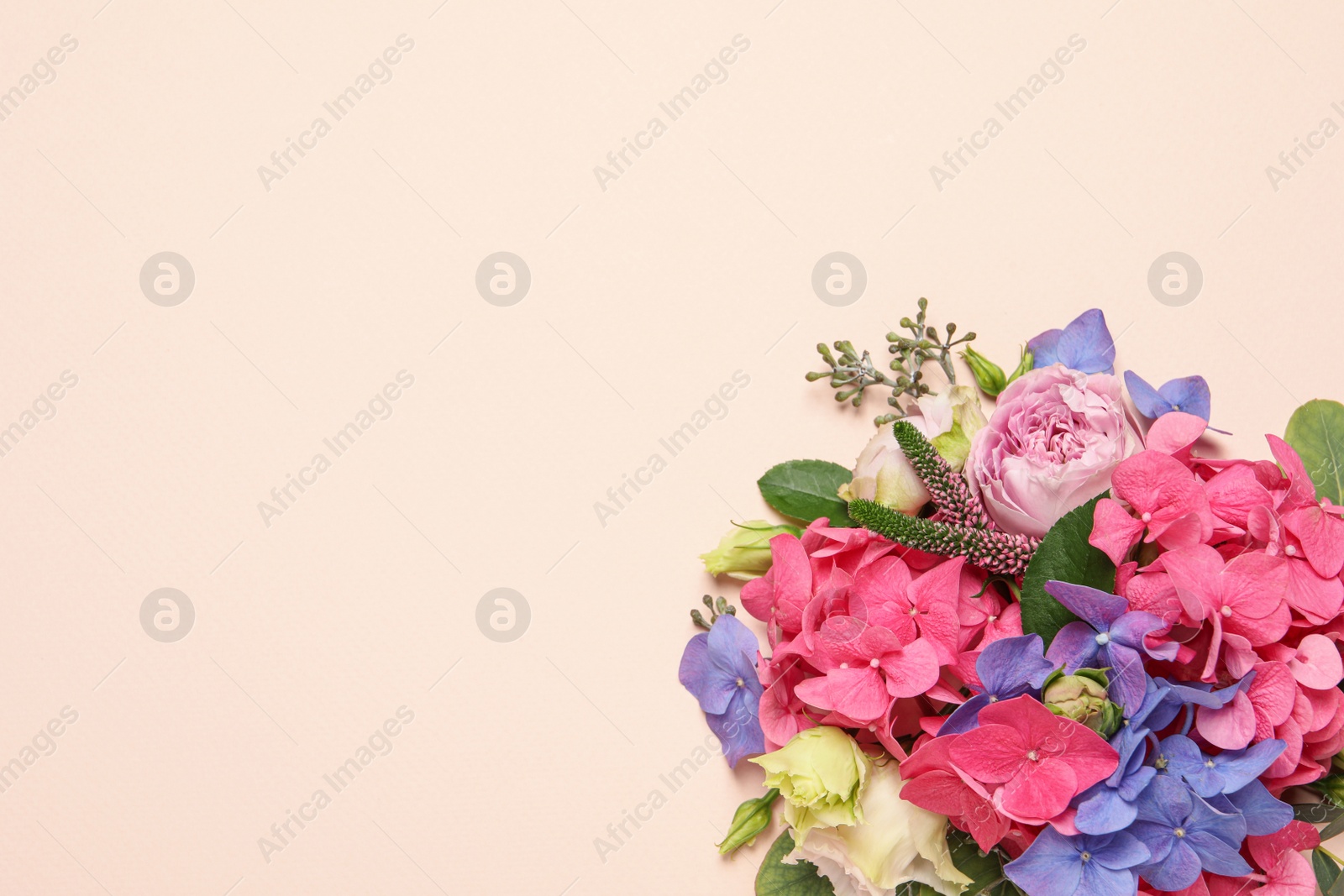 Photo of Beautiful composition with hortensia flowers on beige background, flat lay. Space for text
