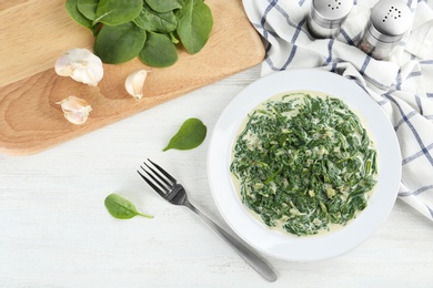 Photo of Tasty spinach dip on white wooden table, flat lay