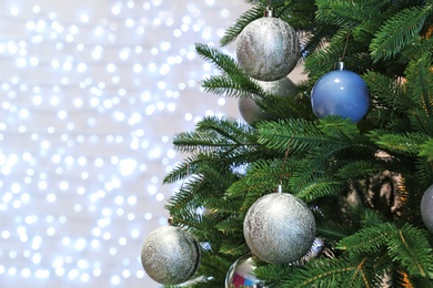 Christmas tree with festive decor against blurred fairy lights