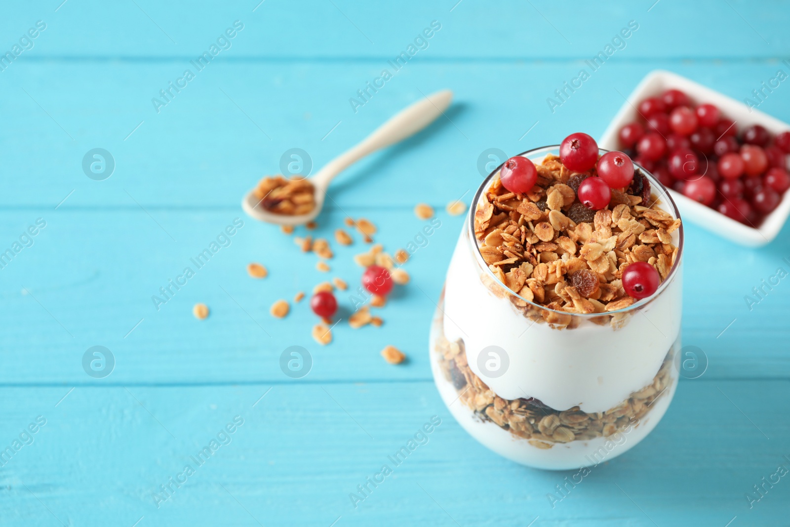 Photo of Tasty homemade granola served on blue wooden table, space for text. Healthy breakfast