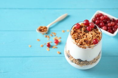 Photo of Tasty homemade granola served on blue wooden table, space for text. Healthy breakfast
