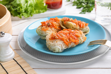 Delicious cabbage rolls served on white wooden table, closeup