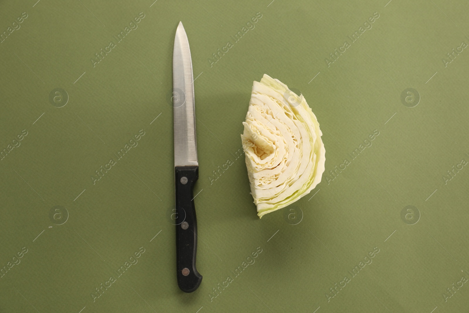 Photo of Cut fresh Chinese cabbage and knife on olive background, flat lay