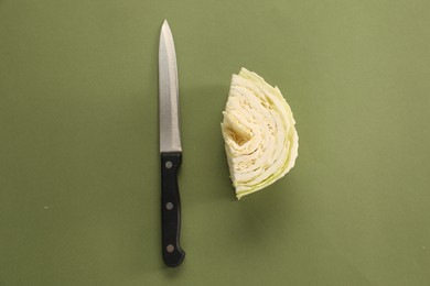 Photo of Cut fresh Chinese cabbage and knife on olive background, flat lay