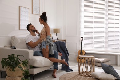 Photo of Lovely couple enjoying each other on sofa at home