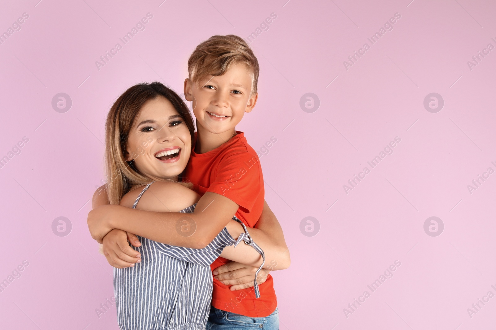 Photo of Portrait of mother and son on color background