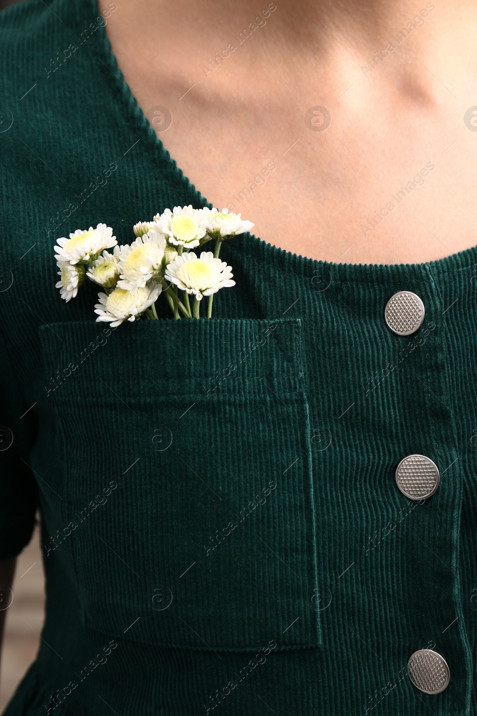 Photo of Woman wearing shirt with flowers in pocket, closeup