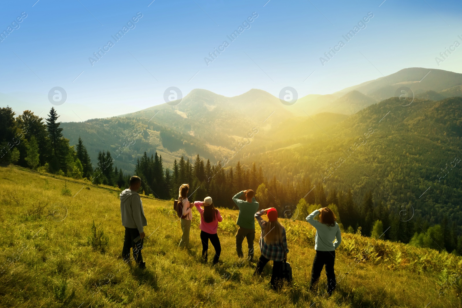 Image of Group of tourists on hill in mountains. Drone photography