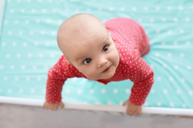 Cute baby girl in crib at home