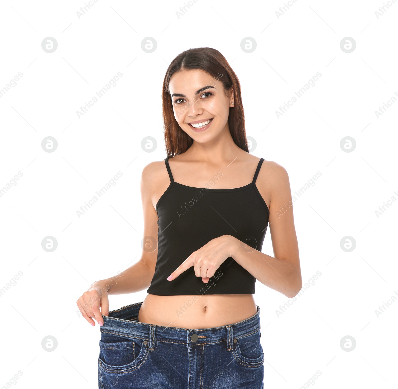 Photo of Slim woman in oversized jeans on white background. Weight loss