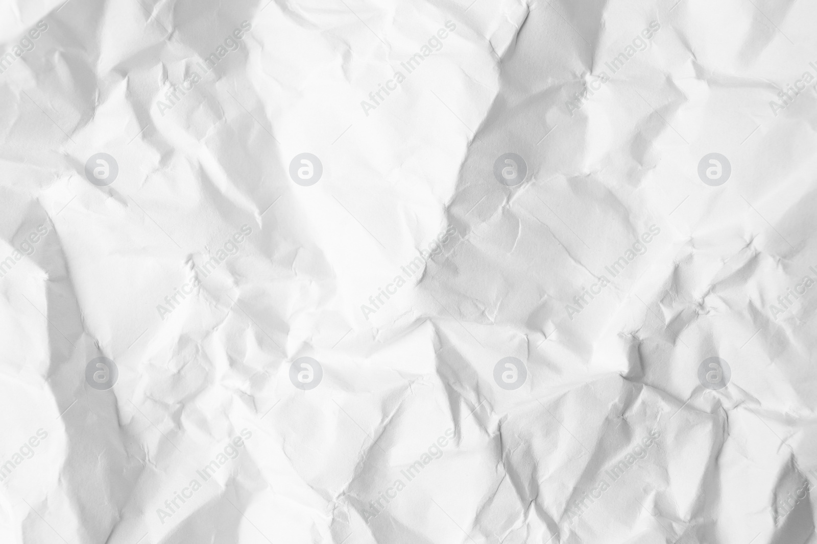 Photo of Sheet of crumpled paper white as background, top view