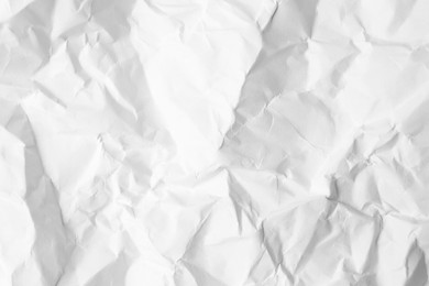 Sheet of crumpled paper white as background, top view