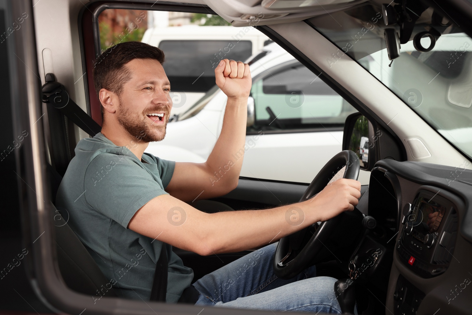 Photo of Listening to radio. Handsome man enjoying music in car