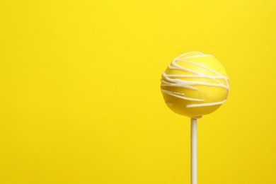 Photo of Bright delicious cake pop on color background. Space for text