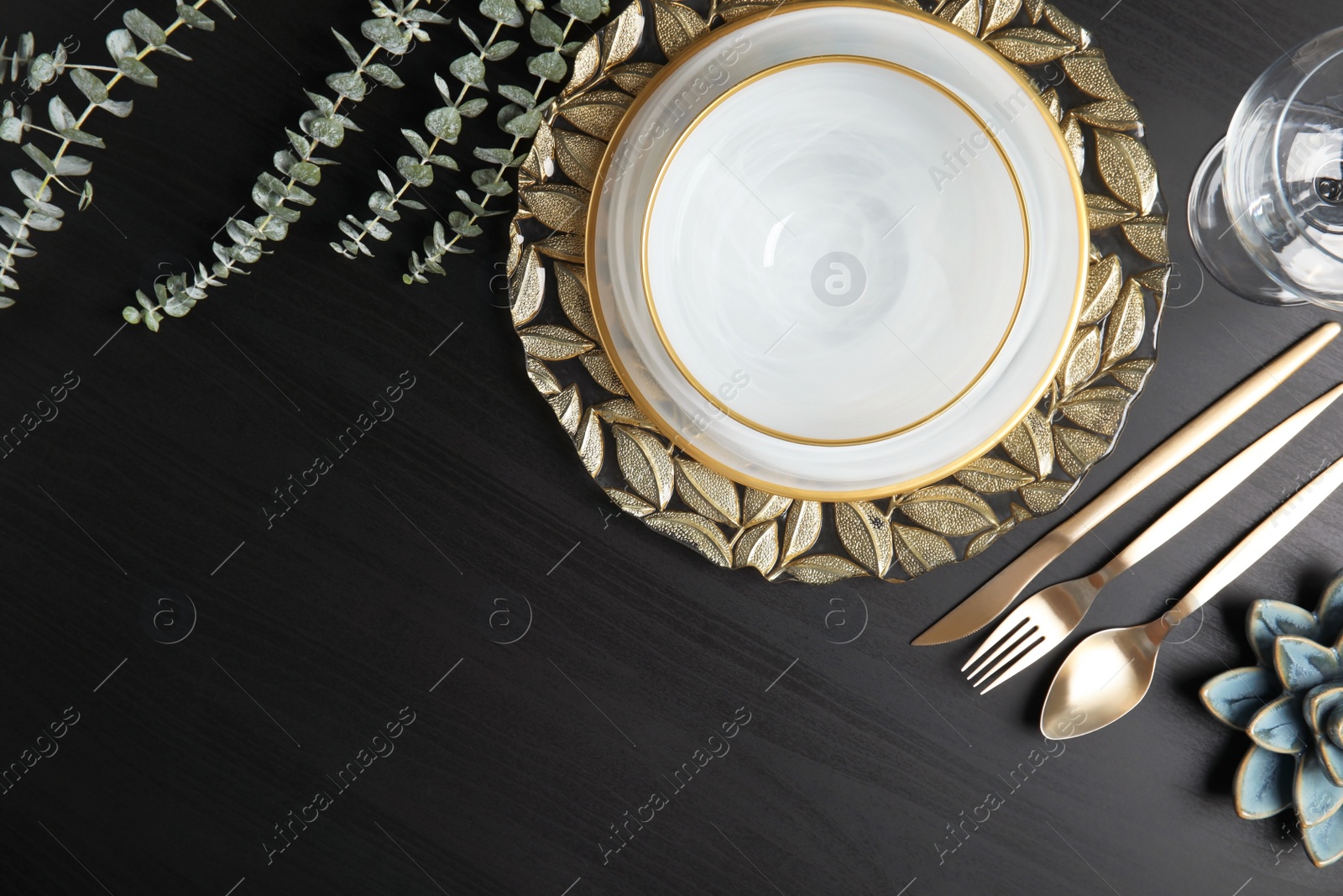 Photo of Elegant table setting and space for text on dark background, top view