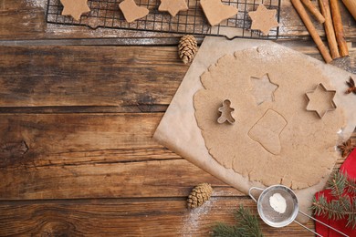 Homemade Christmas cookies. Flat lay composition with dough on wooden table, space for text