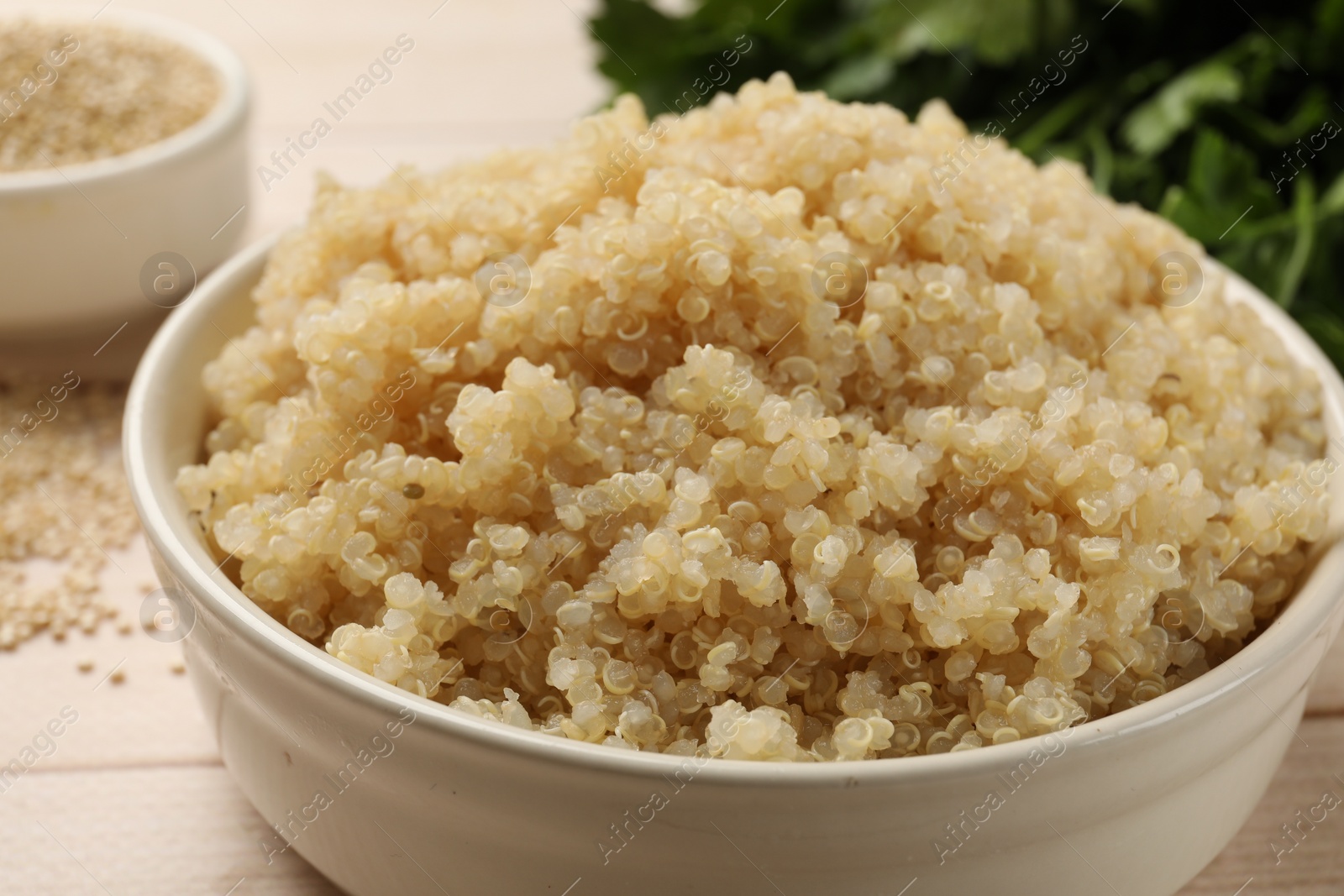 Photo of Tasty quinoa porridge in bowl on table, closeup