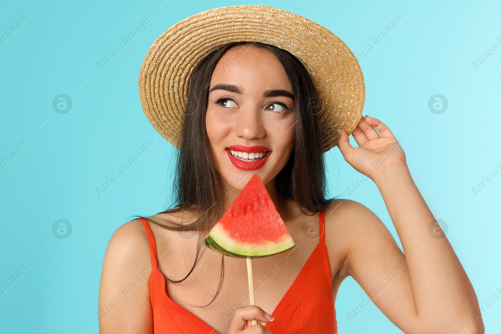 Photo of Beautiful young woman posing with watermelon on color background