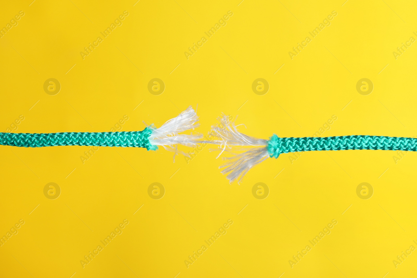 Photo of Rupture of blue rope on color background