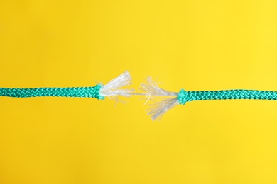 Rupture of blue rope on color background