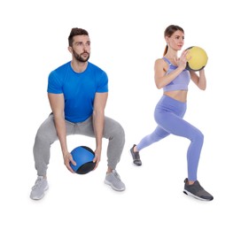 Photo of Athletic couple doing exercise with medicine balls on white background
