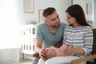 Happy couple with their newborn baby at home