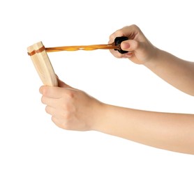 Woman stretching elastic band of slingshot on white background, closeup