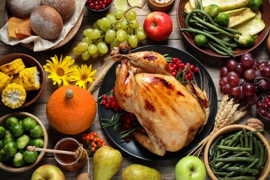 Photo of Flat lay composition with turkey on wooden background. Happy Thanksgiving day