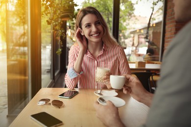 Lovely couple spending time at cafe in morning