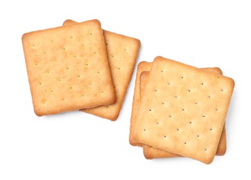 Photo of Many crispy crackers isolated on white, top view. Delicious snack