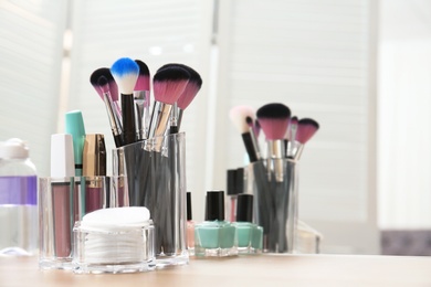 Photo of Organizer with makeup cosmetic products and space for text on dressing table