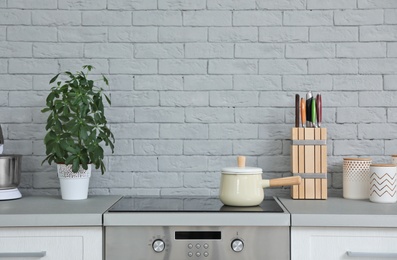 Photo of Modern kitchen interior with new furniture and different utensils