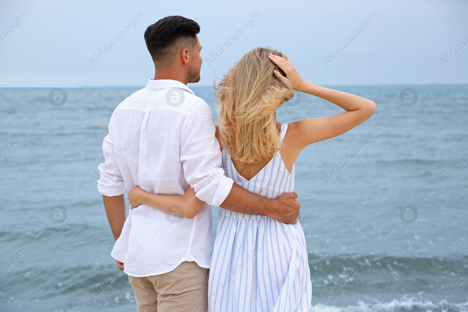 Photo of Happy couple having romantic walk on beach