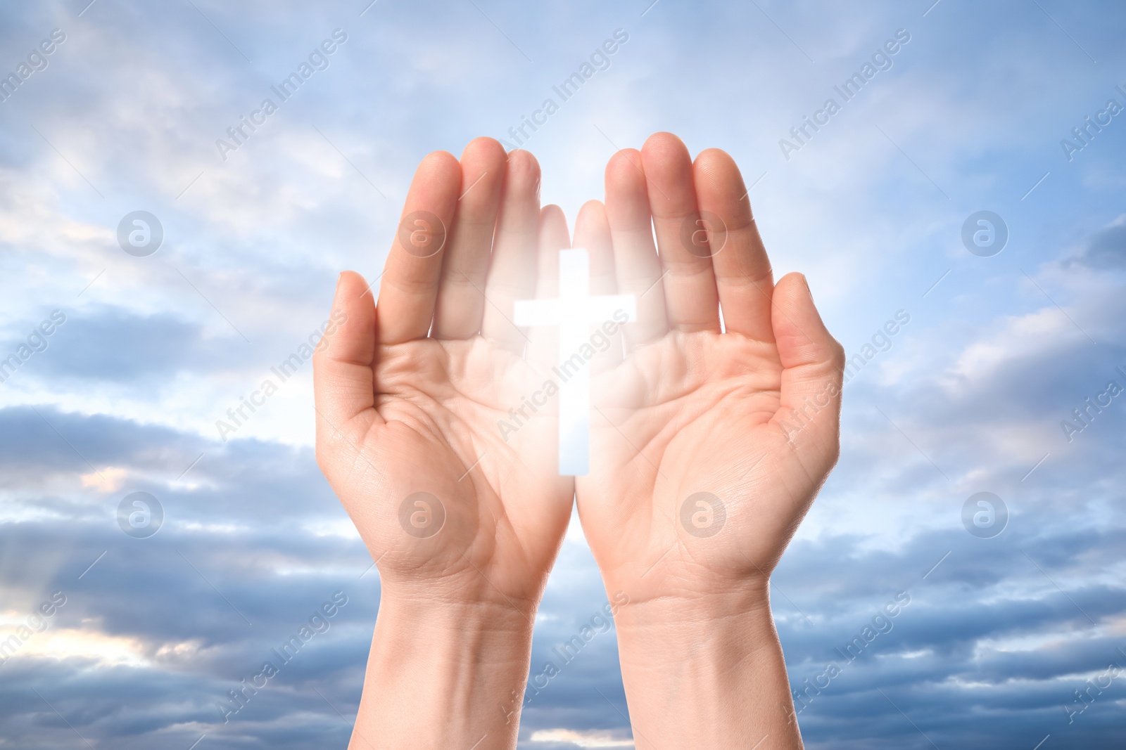 Image of Religion. Christian woman with glowing cross praying against sky, closeup