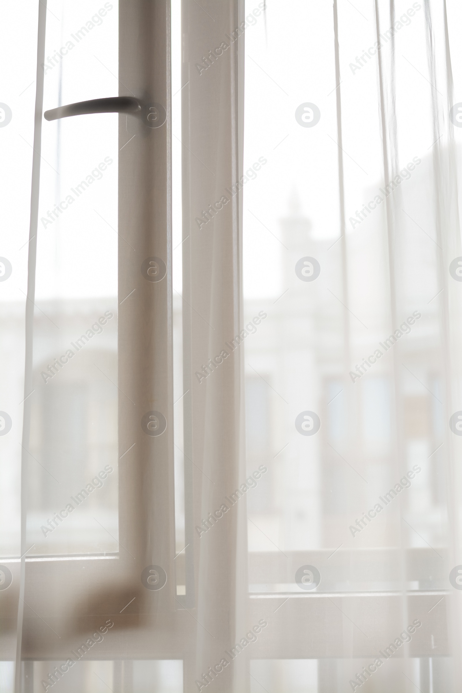 Photo of Window behind white curtain indoors in morning