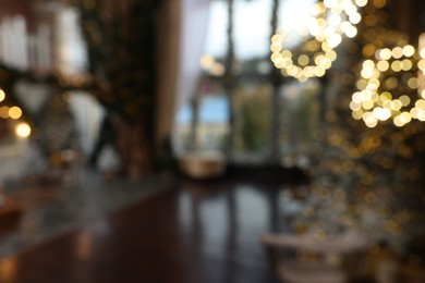 Photo of Blurred view of stylish room interior with Christmas tree and festive decor