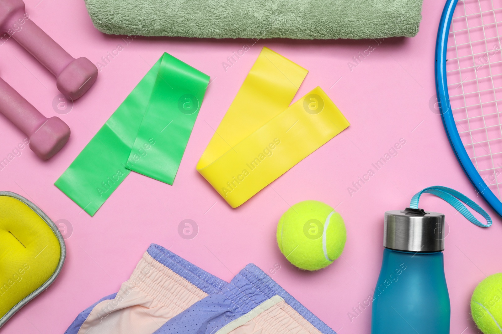 Photo of Flat lay composition with sports equipment on pink background