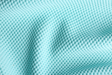 Textured light blue fabric as background, closeup