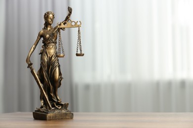 Photo of Figure of Lady Justice on table indoors, space for text. Symbol of fair treatment under law