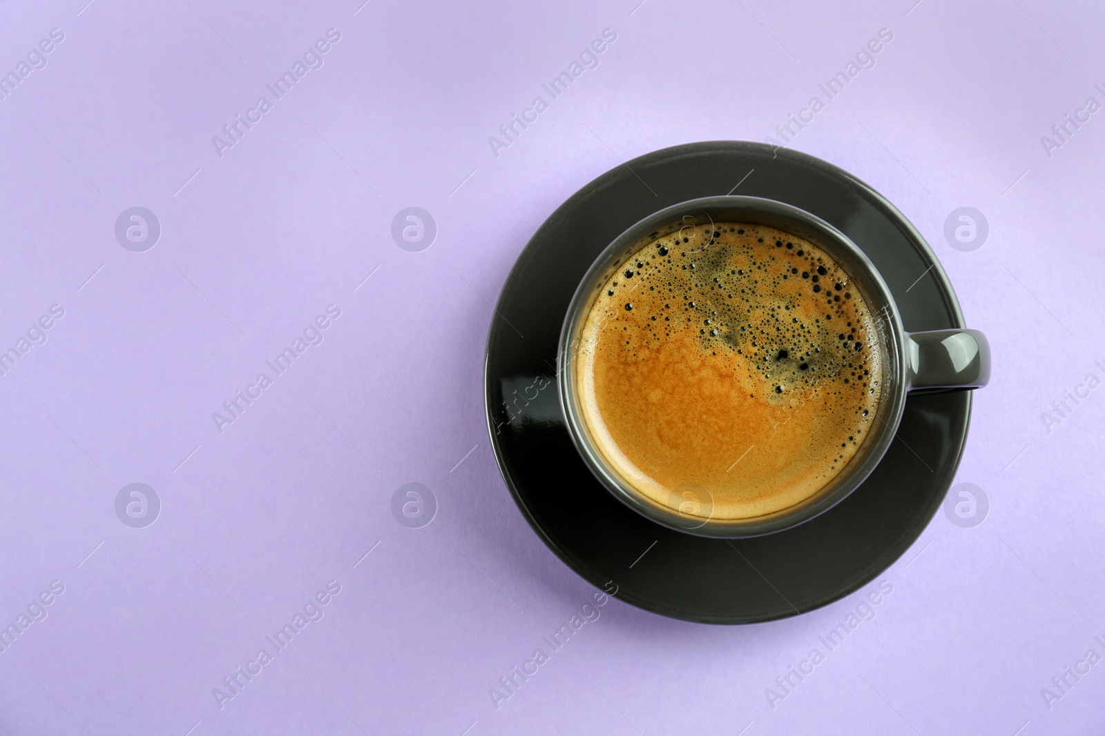 Photo of Cup of tasty coffee on white background, top view. Space for text
