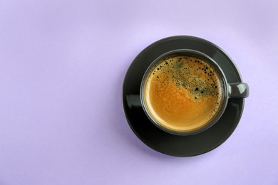 Cup of tasty coffee on white background, top view. Space for text