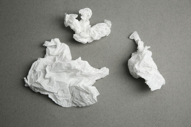 Photo of Used paper tissues on grey background, flat lay