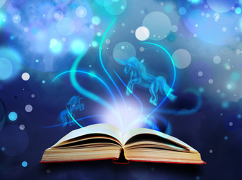 Image of Open book with fairytales and magic lights on blue background. Creative design