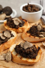 Delicious bruschettas with truffle sauce on table, closeup